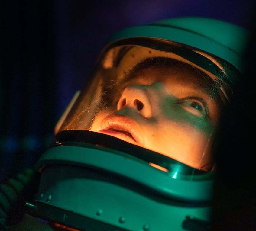 person in space suit looking up